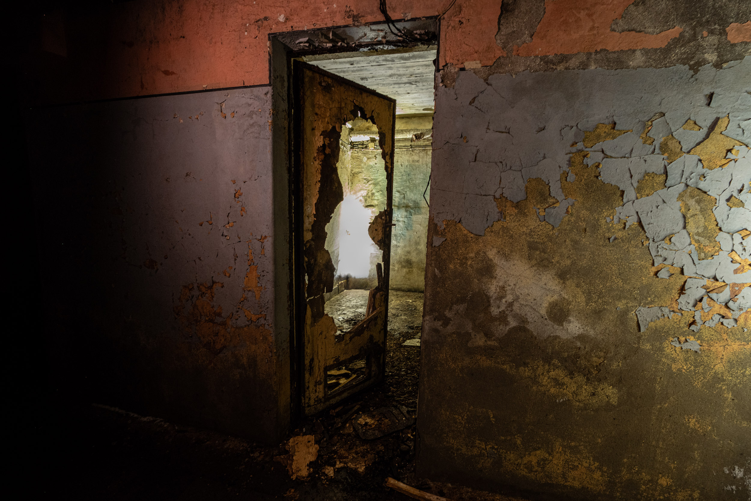 Vom Gang aus kam man in die einzelnen Räume. Die Tür hat die Zeit nicht überstanden - ein großes Loch ist zu sehen.